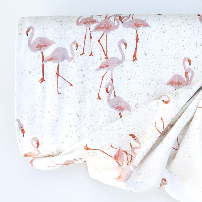 Family Fabrics Stock image of Family Fabrics Flamingo Cotton Jersey Knit - white background with beige splashes and pink flamingos.
