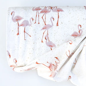 Family Fabrics Flamingo Cotton Jersey Knit - white background with beige splashes and pink flamingos.