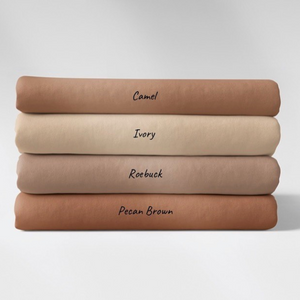 A stack of 4 Family Fabrics solid cotton jersey knits in shades of brown and beige. The shades are camel, ivory, roebuck and pecan brown
