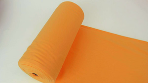 Photo of a roll of Lillestoff organic cotton jersey ribbing in the colour ochre.