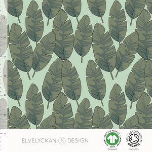 Elvelyckan banana leaf Neo Mint organic jersey cotton knit fabric.  With green banana leaves on a light green background