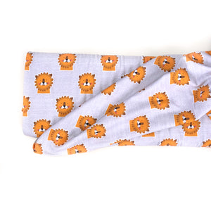 Lillestoff organic jersey knit fabric in Mr Leo design. Pale grey background with yellow/orange lion faces